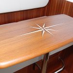 Pilothouse teak table with carved inlay