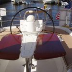 Binacle-mounted teak cockpit table leaves unfolded