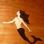 Carved teak mermaid inlay for boat table